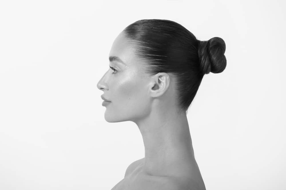Beautiful woman's side profile after a liquid nose job