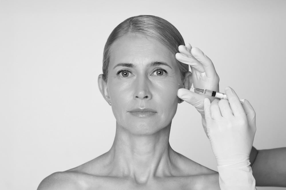 Woman looks straight ahead as she undergoes Renuva treatment for facial volume loss