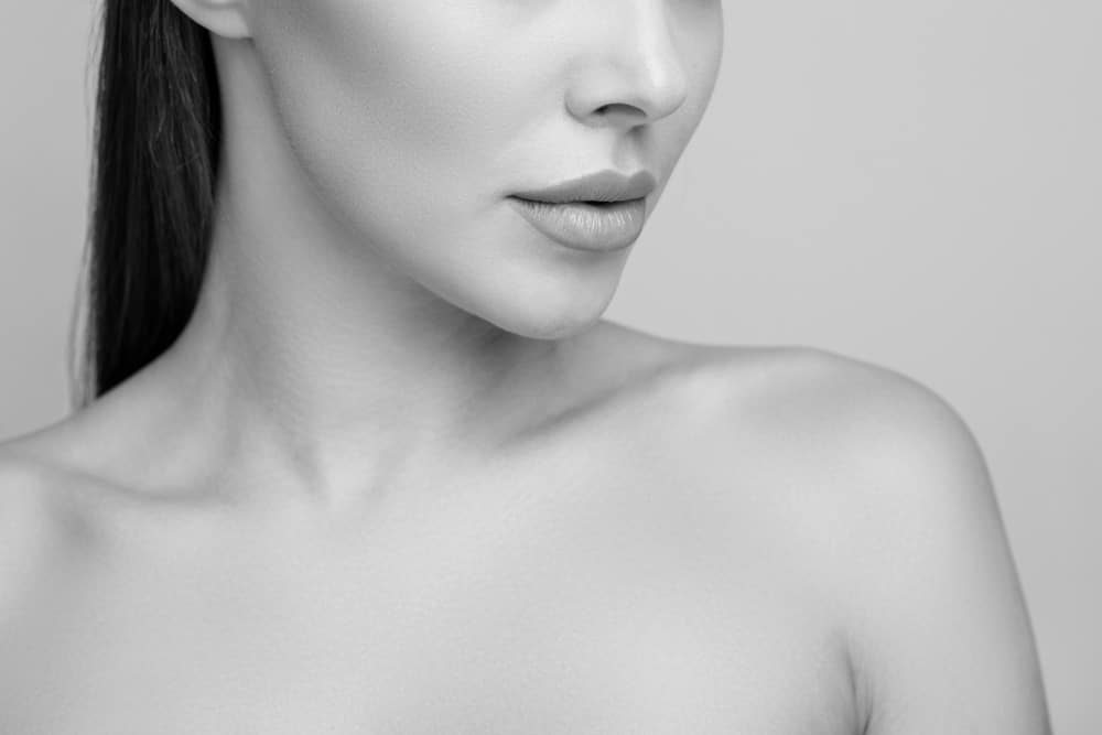 Close-up of a woman with natural-looking fuller lips after lip filler treatment.